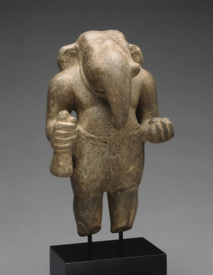 Stone sculpture of a figure with an elephant-like head.